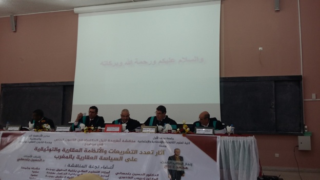 مناقشة أطروحة لنيل الدكتوراه في القانون الخاص في موضوع: آثار تعدد التشريعات والأنظمة العقارية والتوثيقية على السياسة العقارية بالمغرب  تحت إشراف الدكتور الحسين بلحساني للباحث محمد زعاج مناقشة أطروحة لنيل الدكتوراه في القانون الخاص في موضوع: آثار تعدد التشريعات والأنظمة العقارية والتوثيقية على السياسة العقارية بالمغرب  تحت إشراف الدكتور الحسين بلحساني للباحث محمد زعاج